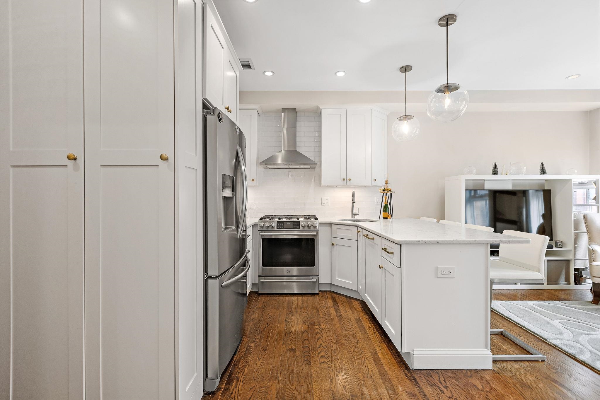 501 9th Street, Unit 309 Hoboken, NJ 07030 - Photo 5 of 18 a large kitchen with a stove and a refrigerator