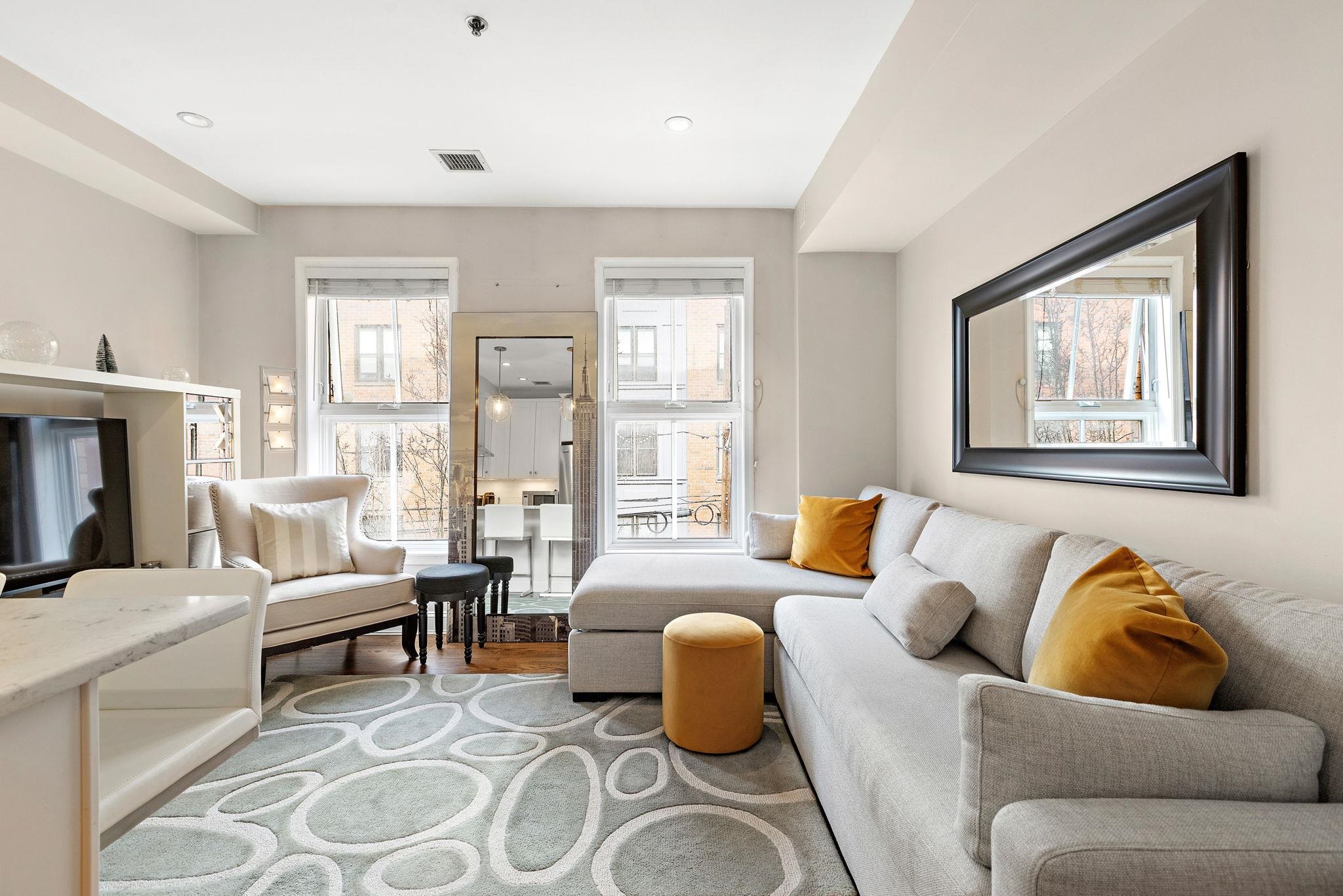 501 9th Street, Unit 309 Hoboken, NJ 07030 - Photo 6 of 18 a living room with furniture and a large window