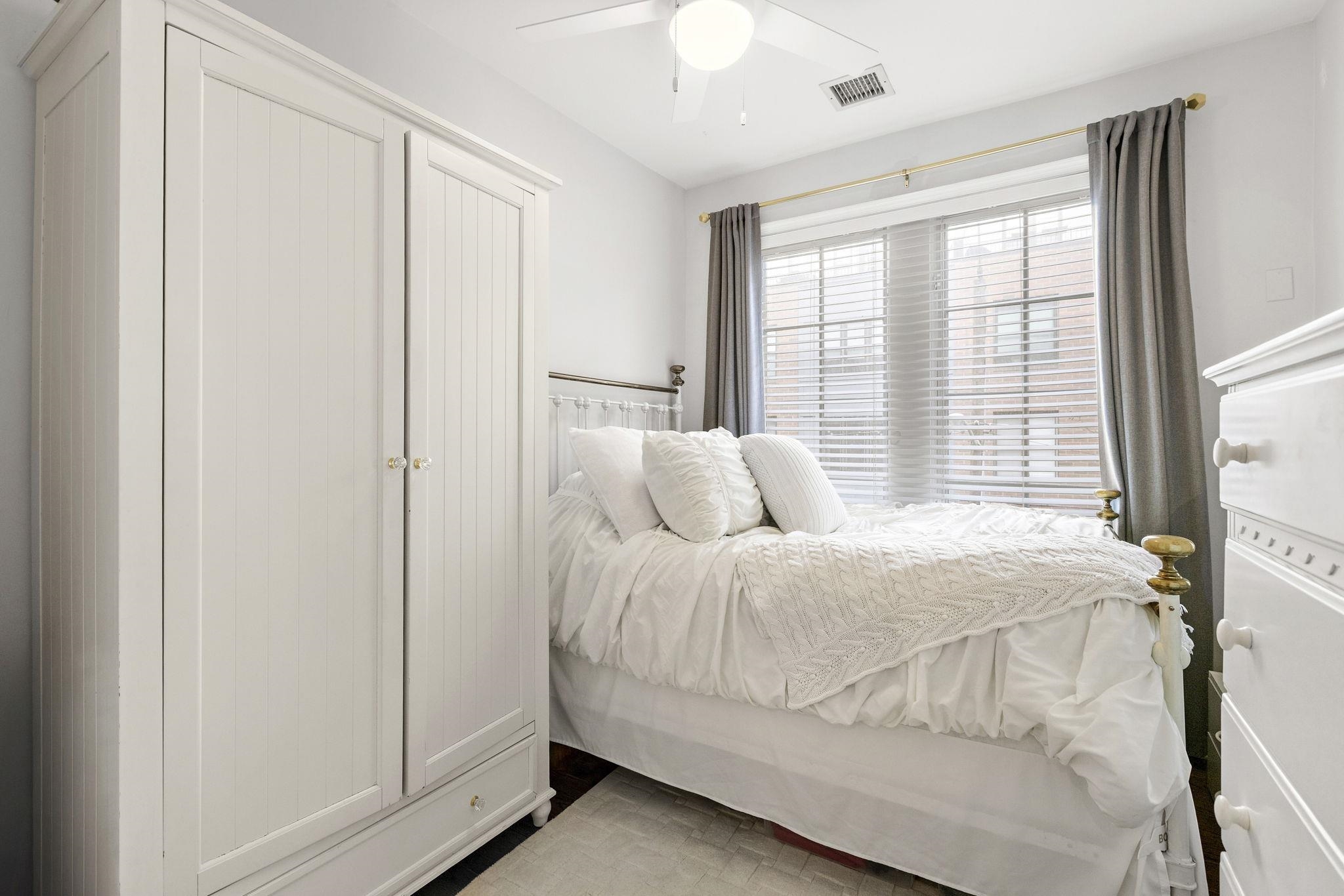 501 9th Street, Unit 309 Hoboken, NJ 07030 - Photo 9 of 18 a bed sitting in a bedroom next to a window