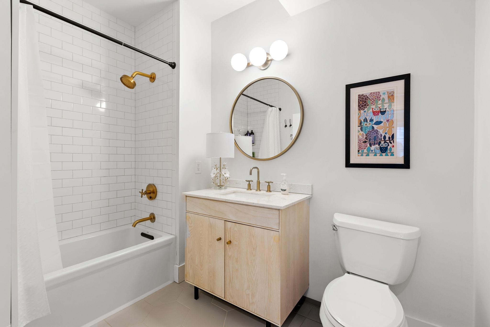 501 9th Street, Unit 309 Hoboken, NJ 07030 - Photo 10 of 18 a bathroom with a toilet a sink and a bathtub