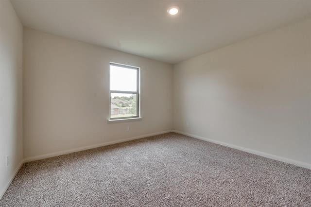 13609 Mineral Road Ponder, TX 76259 - Photo 13 of 21 Room featuring neutral-toned walls, recessed lighting, and a single window with a white frame