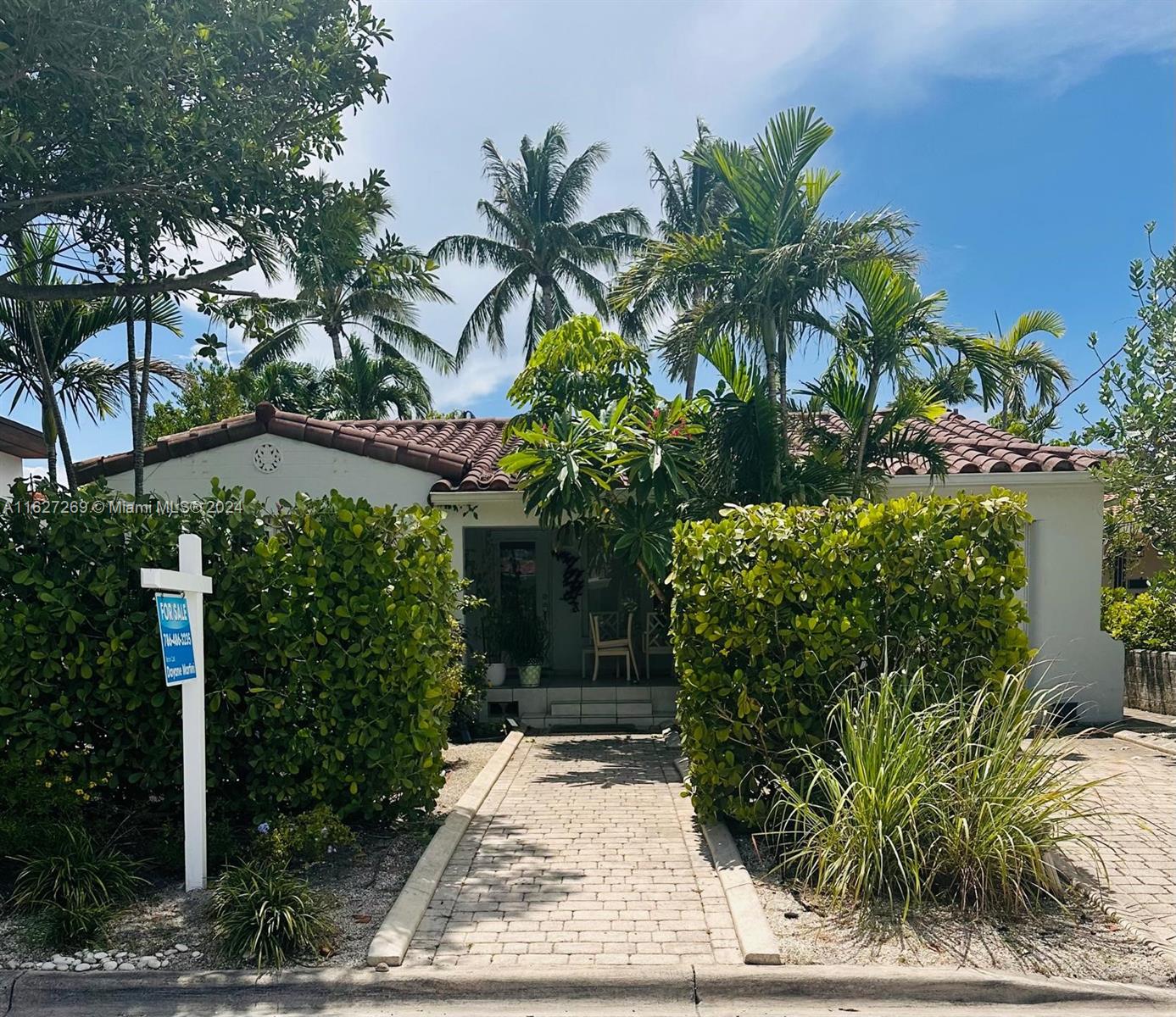 a couple of potted plants in front of door