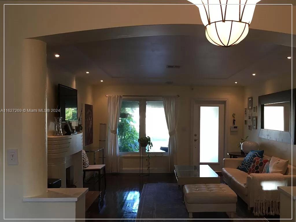 8818 Abbott Avenue Surfside, FL 33154 - Photo 13 of 28 a living room with furniture and a glass door