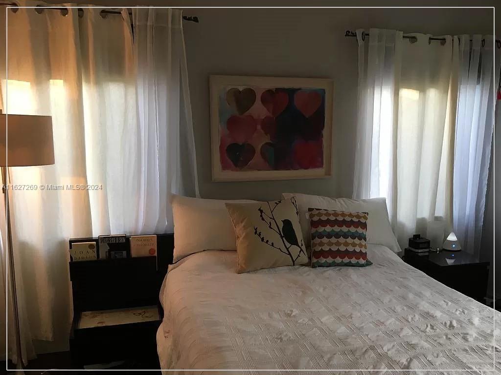 8818 Abbott Avenue Surfside, FL 33154 - Photo 17 of 28 a bedroom with a bed and a window