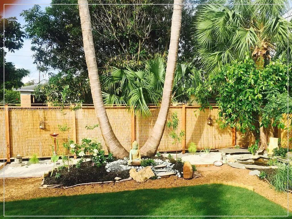 8818 Abbott Avenue Surfside, FL 33154 - Photo 2 of 28 a view of a swimming pool with a lawn chairs and plants