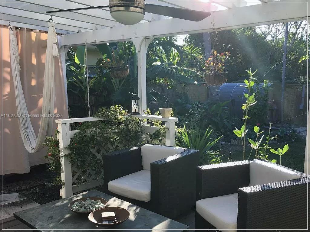 8818 Abbott Avenue Surfside, FL 33154 - Photo 3 of 28 a balcony with furniture and a potted plant