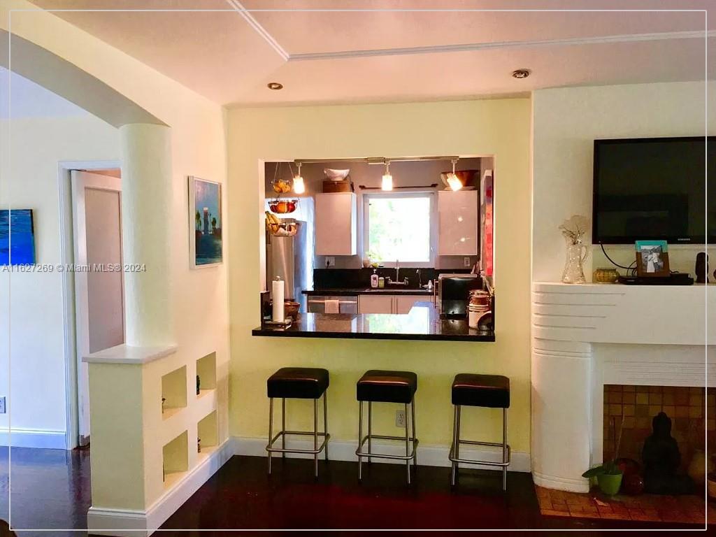 8818 Abbott Avenue Surfside, FL 33154 - Photo 5 of 28 a kitchen with stainless steel appliances kitchen island granite countertop a stove and a refrigerator