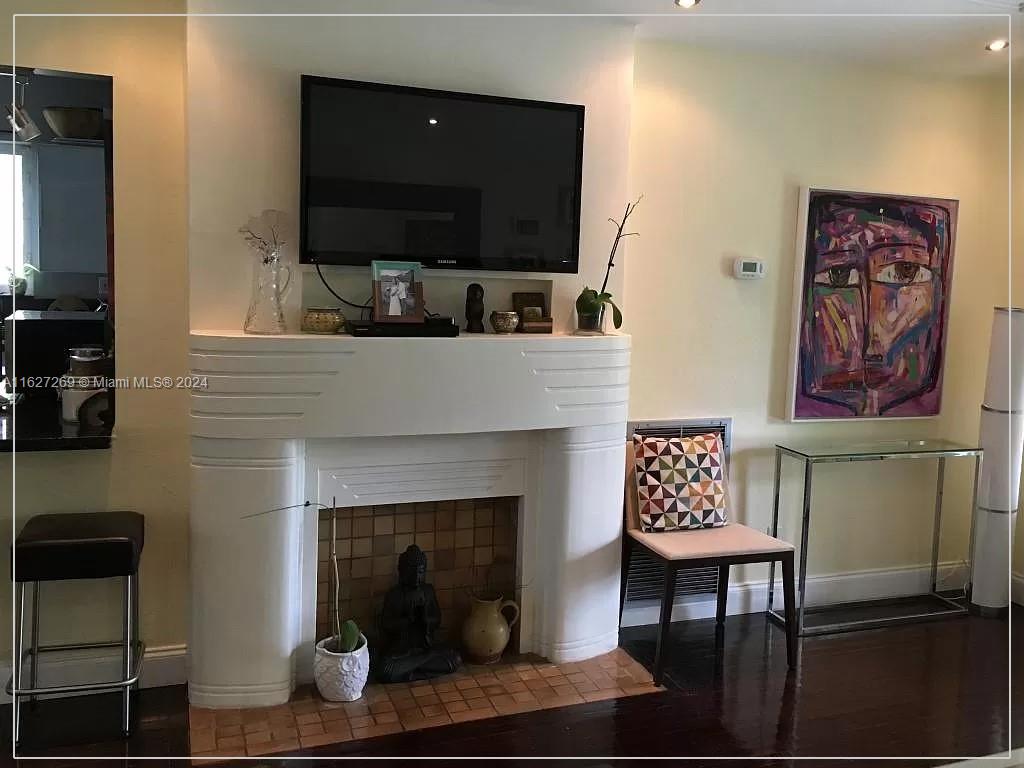 8818 Abbott Avenue Surfside, FL 33154 - Photo 6 of 28 a living room with furniture a fireplace and a flat screen tv