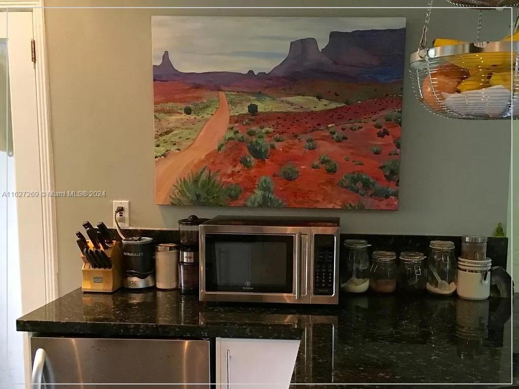 8818 Abbott Avenue Surfside, FL 33154 - Photo 9 of 28 a kitchen with a stove and a microwave