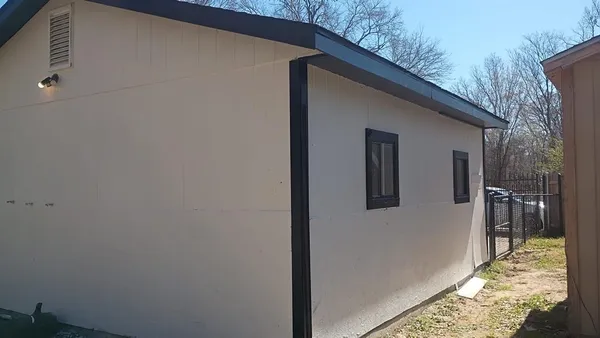 a view of a house with a backyard