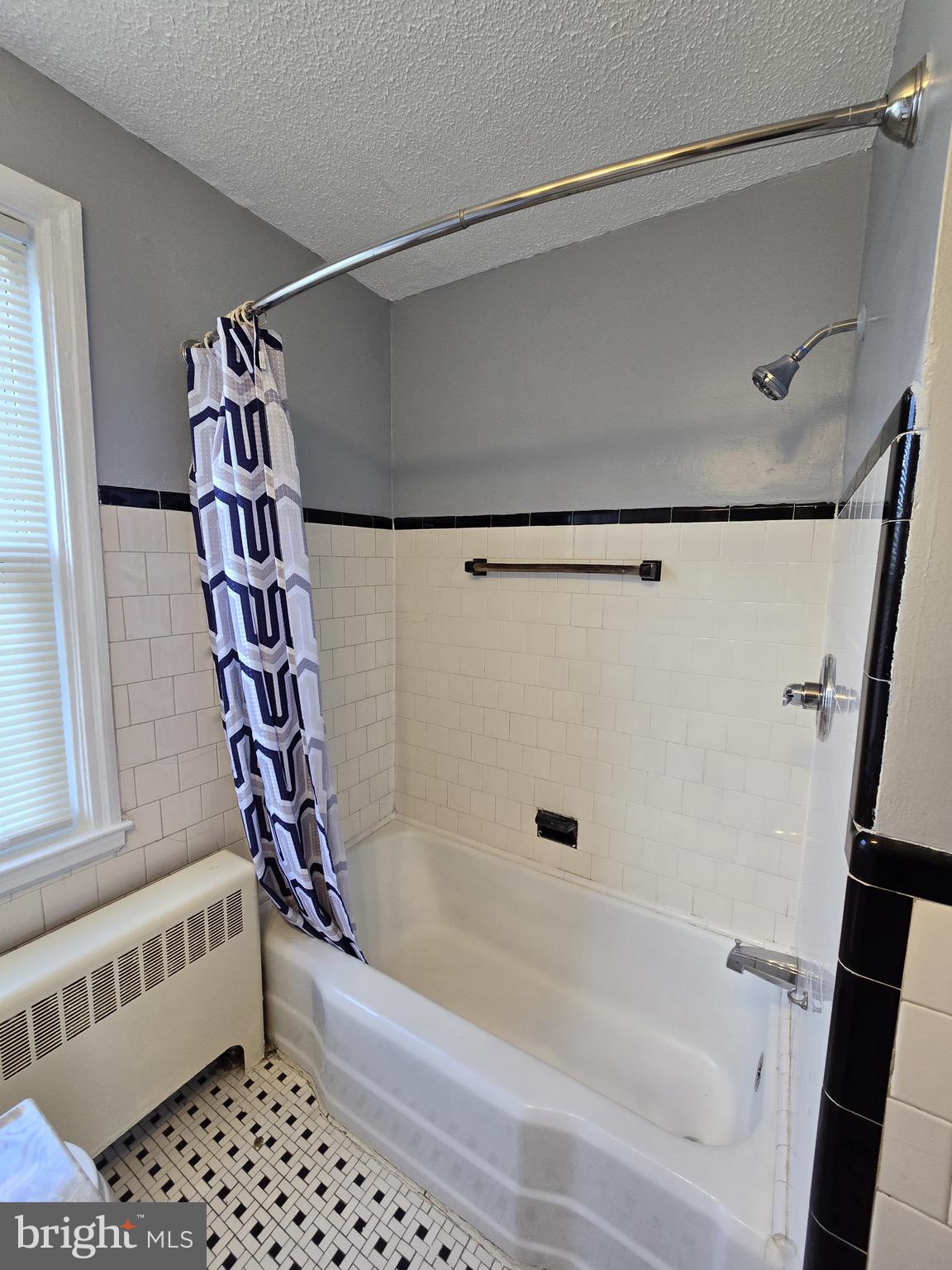 6105 Frederick Road Catonsville, MD 21228 - Photo 16 of 38 a bathroom with a bathtub and a shower