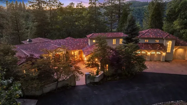 an aerial view of a house with yard swimming pool and outdoor seating