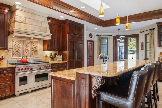 a living room with furniture a fireplace and a large window
