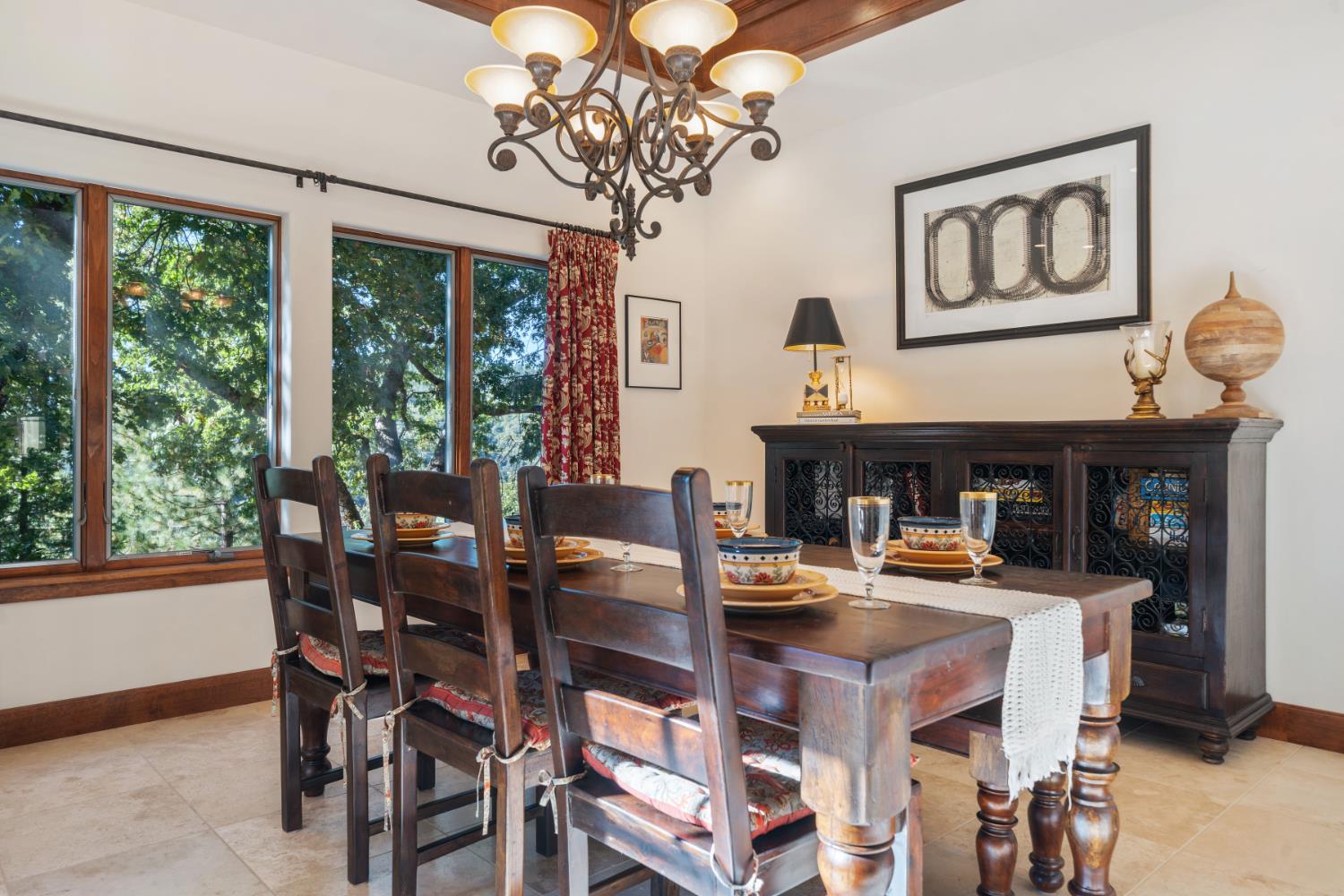 4581 Highway 4 Murphys, CA 95247 - Photo 23 of 65 a dining room with wooden floor a chandelier a wooden table and chairs