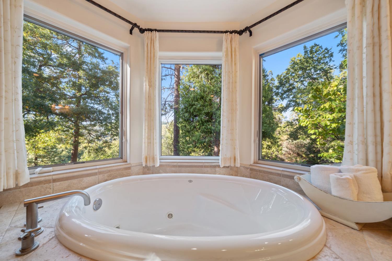 4581 Highway 4 Murphys, CA 95247 - Photo 28 of 58 a white bath tub sitting in a bathroom next to a window