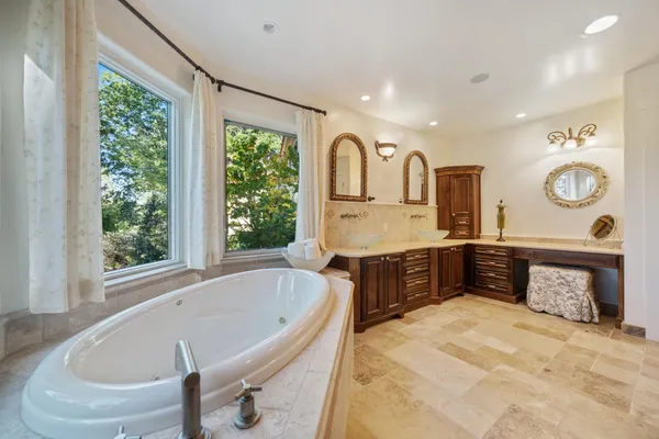 a bathroom with a granite countertop sink a toilet and bathtub