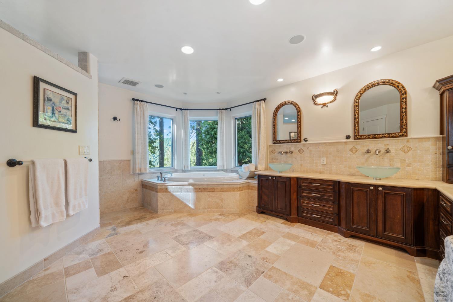 4581 Highway 4 Murphys, CA 95247 - Photo 31 of 65 a spacious bathroom with a granite countertop sink and a large mirror