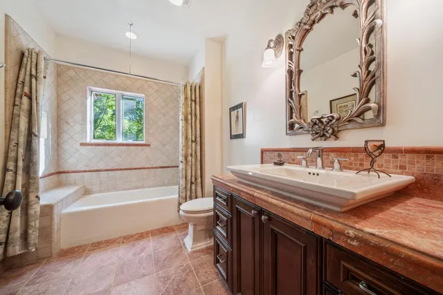 a bathroom with a toilet a sink and mirror