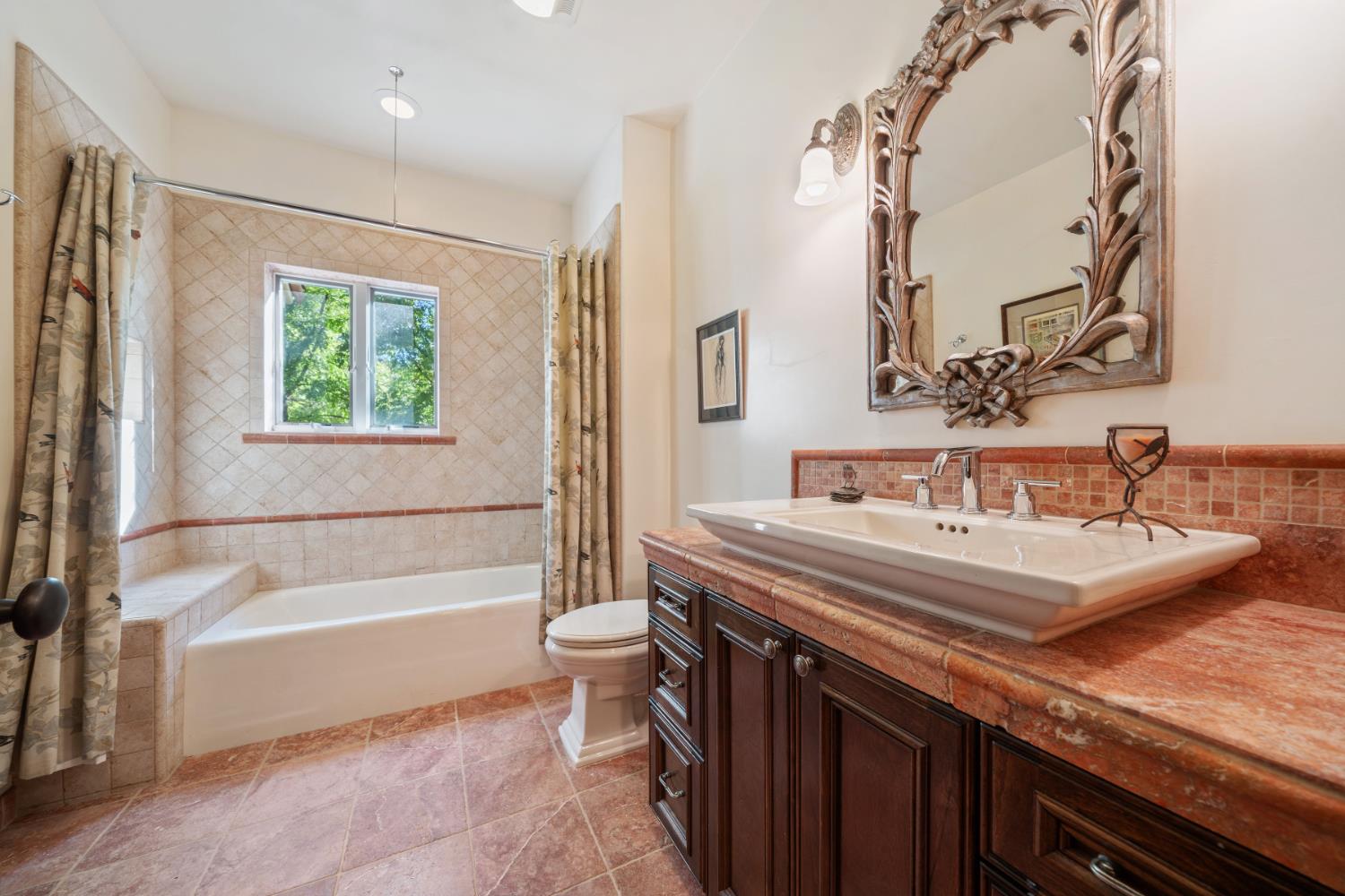 4581 Highway 4 Murphys, CA 95247 - Photo 38 of 65 a bathroom with a granite countertop sink a toilet and bathtub