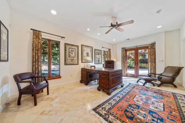 a view of a patio with a table chairs and a small yard