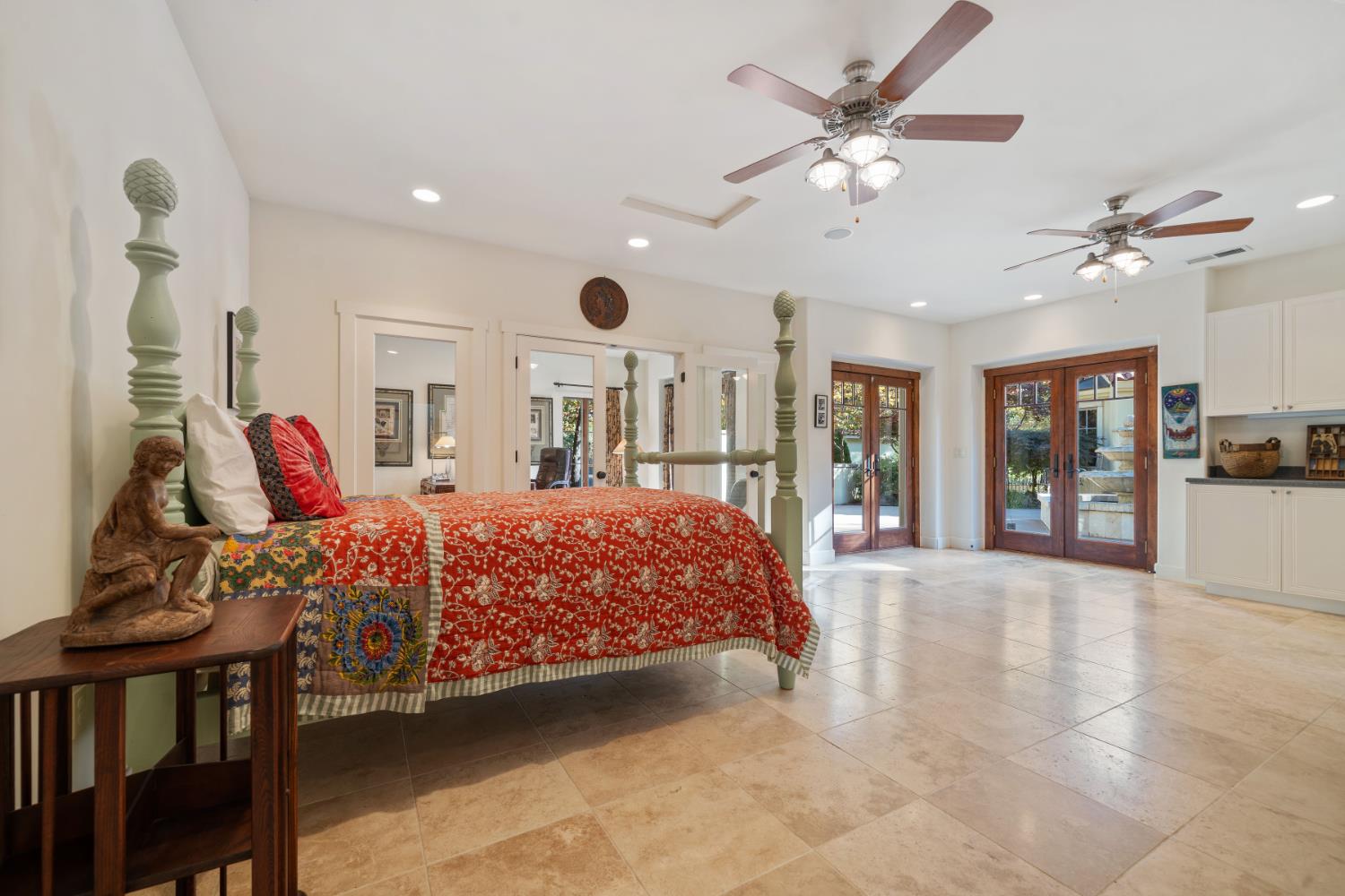 4581 Highway 4 Murphys, CA 95247 - Photo 42 of 65 a spacious bedroom with a large bed and a chandelier