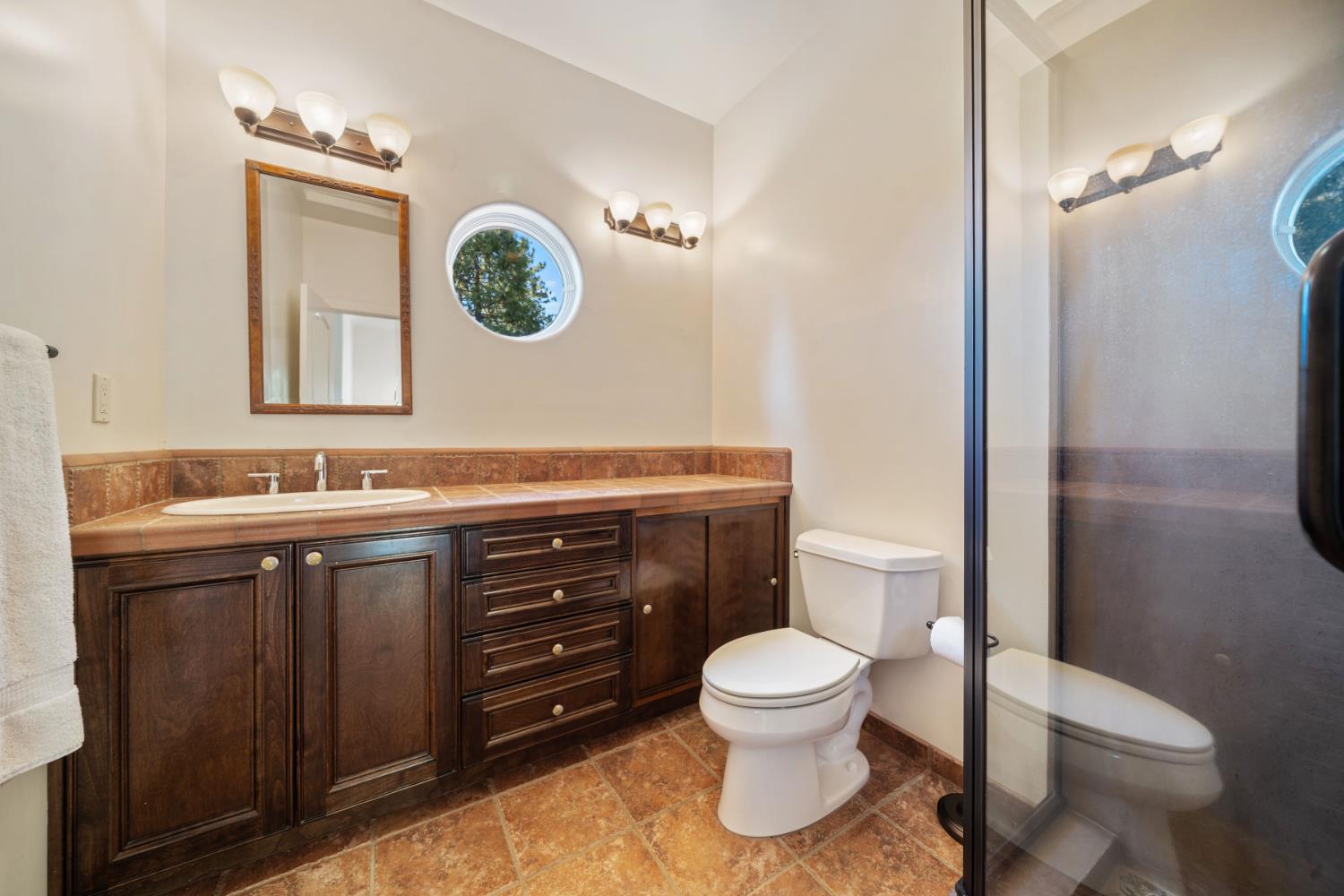 4581 Highway 4 Murphys, CA 95247 - Photo 48 of 65 a bathroom with a toilet a sink and mirror