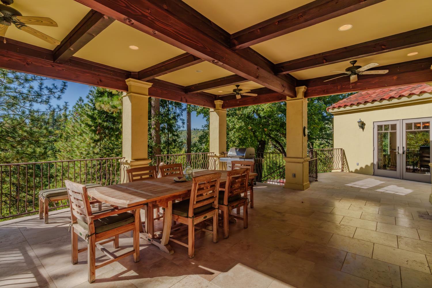 4581 Highway 4 Murphys, CA 95247 - Photo 51 of 65 a view of a patio with a table and chairs under an umbrella