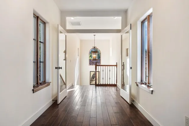 a living room with fireplace furniture and a rug