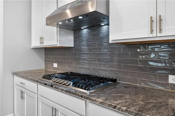 a close view of a stove a microwave and cabinets