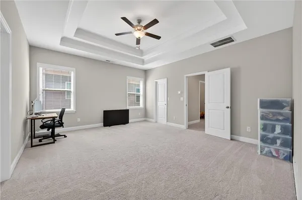 a view of a livingroom with furniture and a ceiling fan