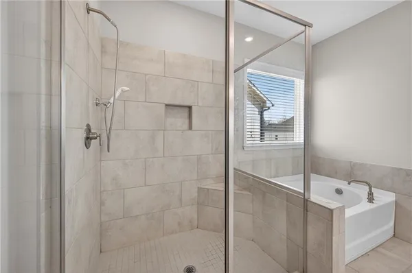 a bathroom with a bathtub and shower