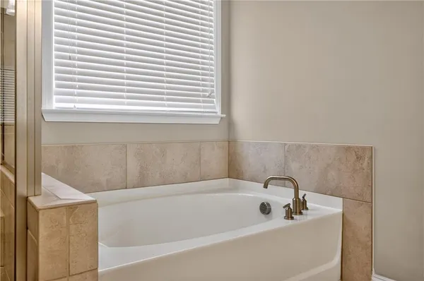 a white bath tub sitting next to a white sink