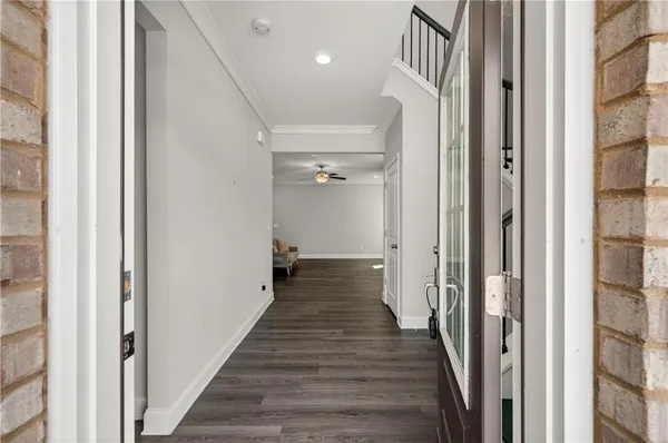 a view of a hallway with a wooden floor