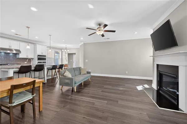a living room with furniture wooden floor and a flat screen tv
