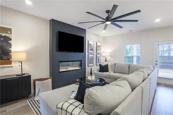 a living room with furniture a fireplace and a flat screen tv