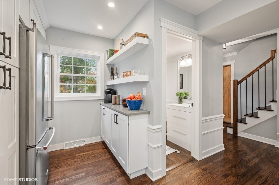 111 Riverside Drive Northfield, IL 60093 - Photo 11 of 33 a hallway with white cabinets and wooden floor