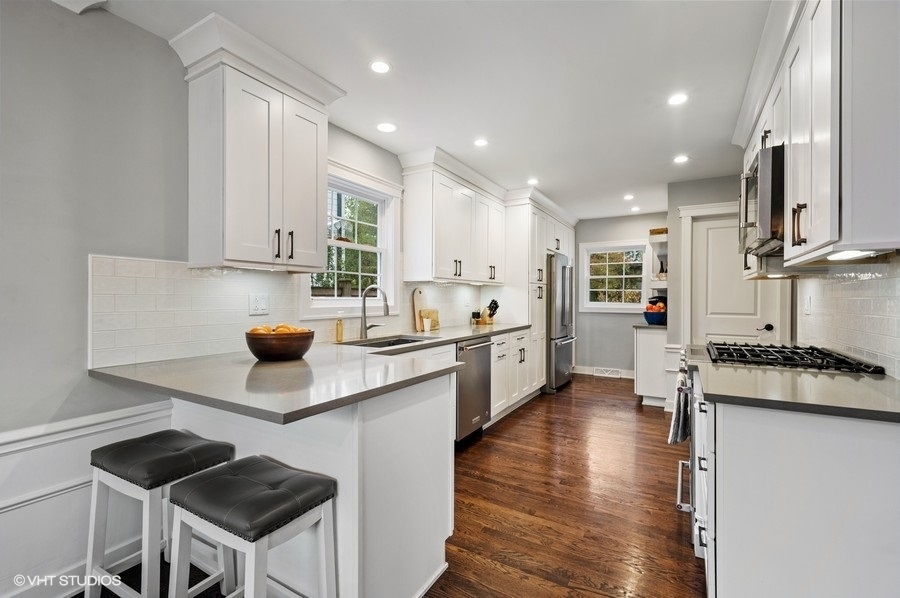 111 Riverside Drive Northfield, IL 60093 - Photo 12 of 33 a kitchen with a sink cabinets and wooden floor