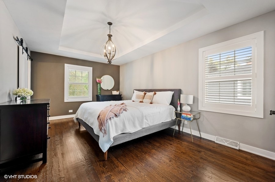 111 Riverside Drive Northfield, IL 60093 - Photo 18 of 33 a bedroom with bed and wooden floor