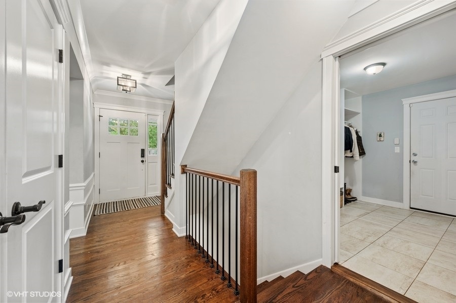 111 Riverside Drive Northfield, IL 60093 - Photo 3 of 33 a view of a hallway view with wooden floor and staircase