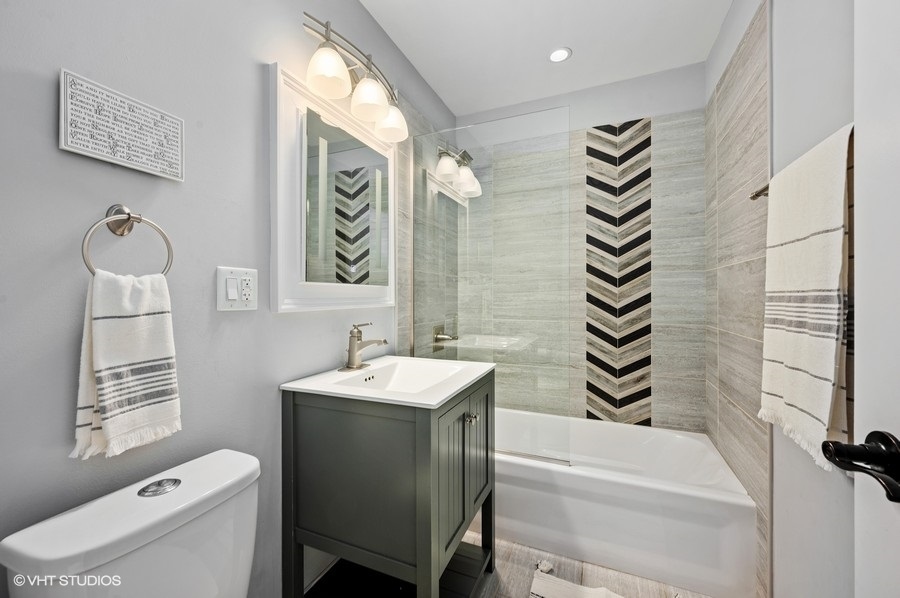 111 Riverside Drive Northfield, IL 60093 - Photo 22 of 33 a bathroom with a sink a toilet and a shower