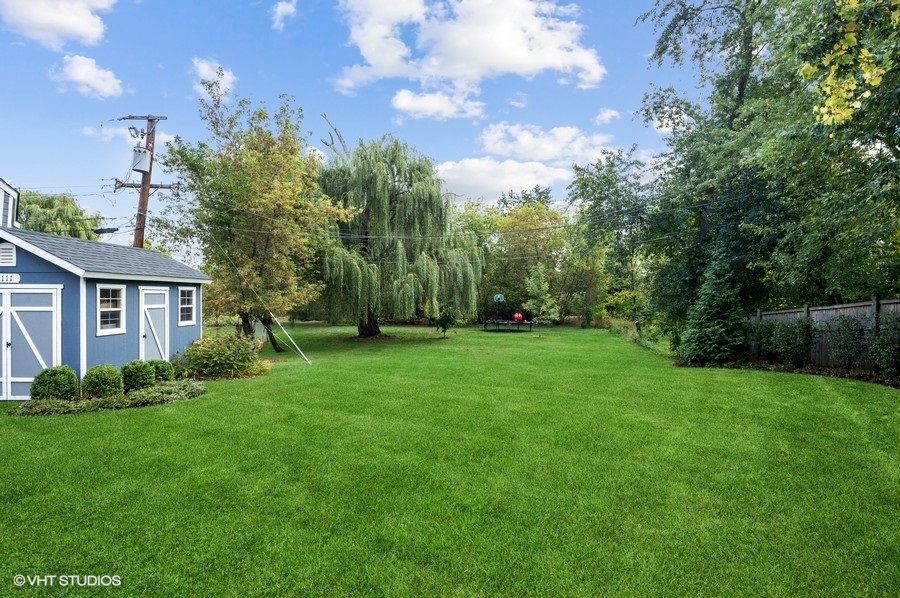 111 Riverside Drive Northfield, IL 60093 - Photo 28 of 33 a view of a yard in front of a house with a large tree