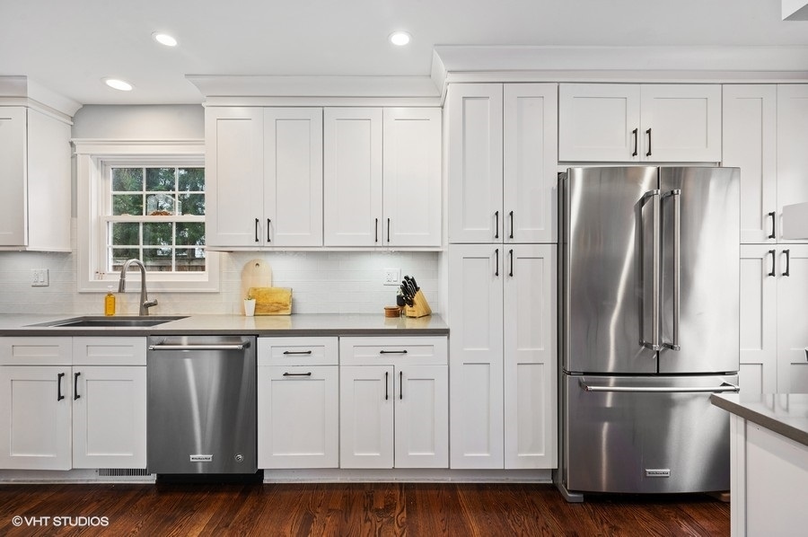 111 Riverside Drive Northfield, IL 60093 - Photo 10 of 33 a kitchen with stainless steel appliances white cabinets and a refrigerator