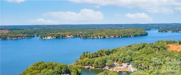 an aerial view of a houses with a lake view