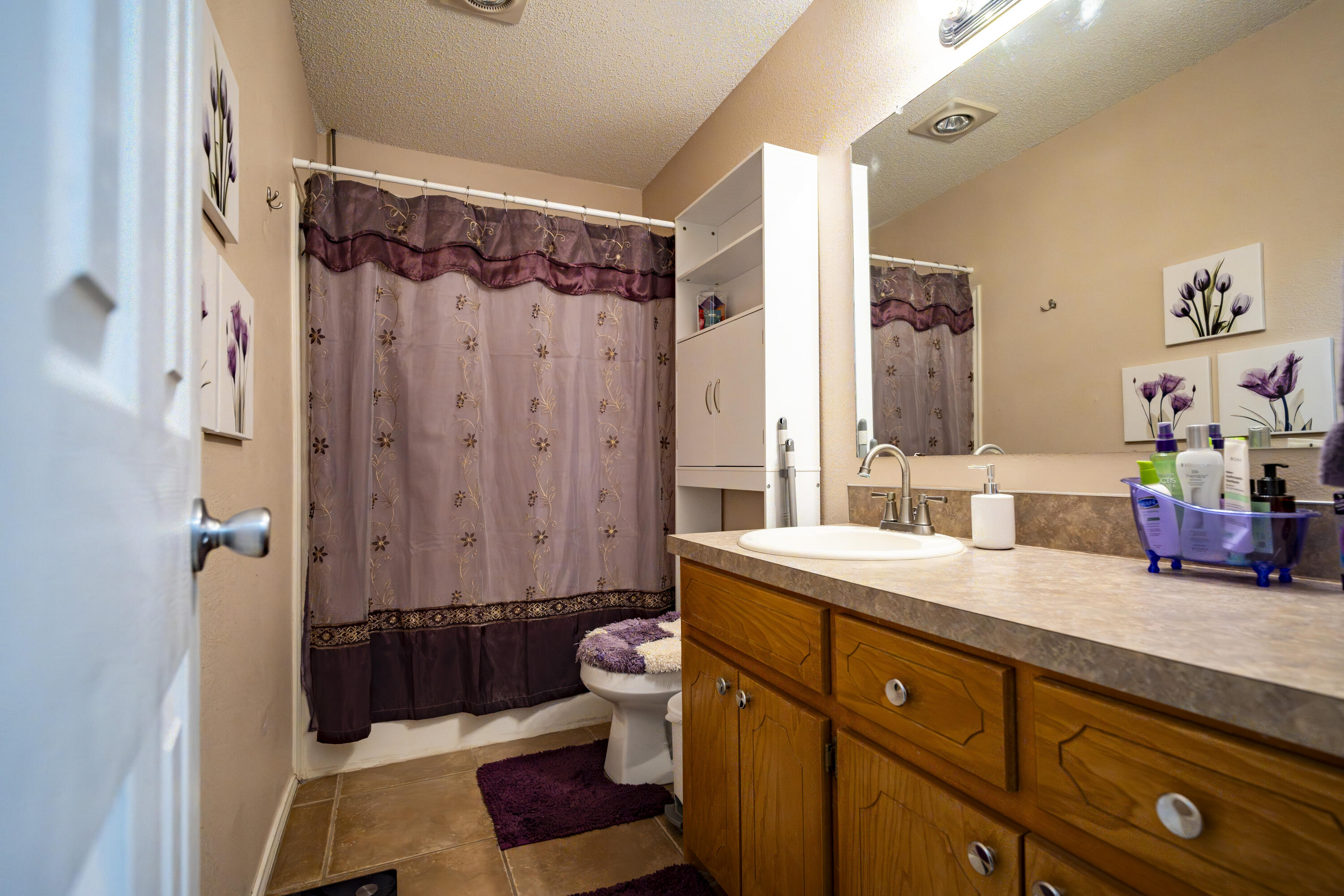 6319 13th Street Lubbock, TX 79416 - Photo 13 of 21 a spacious bathroom with a double vanity sink toilet mirror and shower