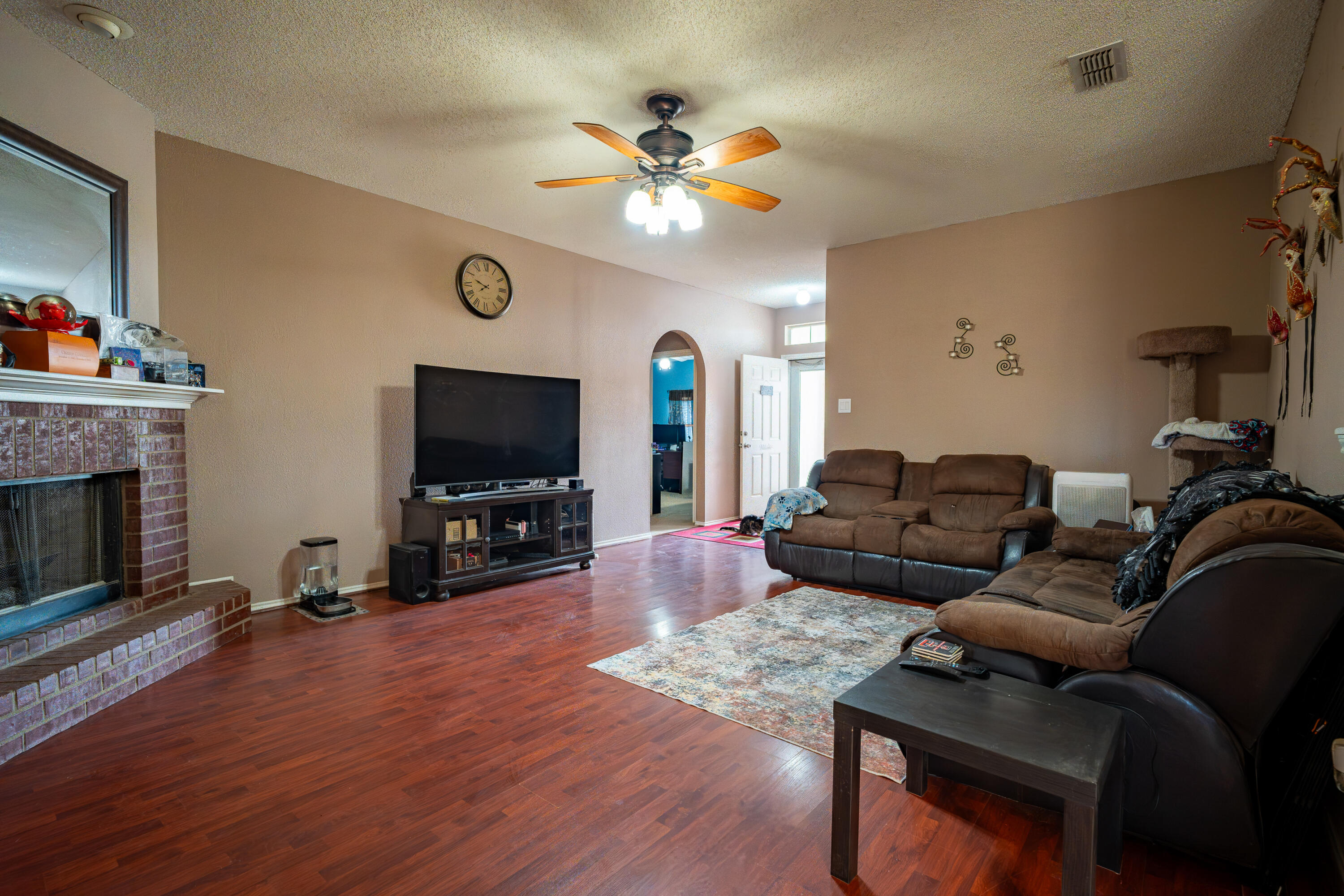 6319 13th Street Lubbock, TX 79416 - Photo 3 of 21 a living room with furniture a flat screen tv and a fireplace