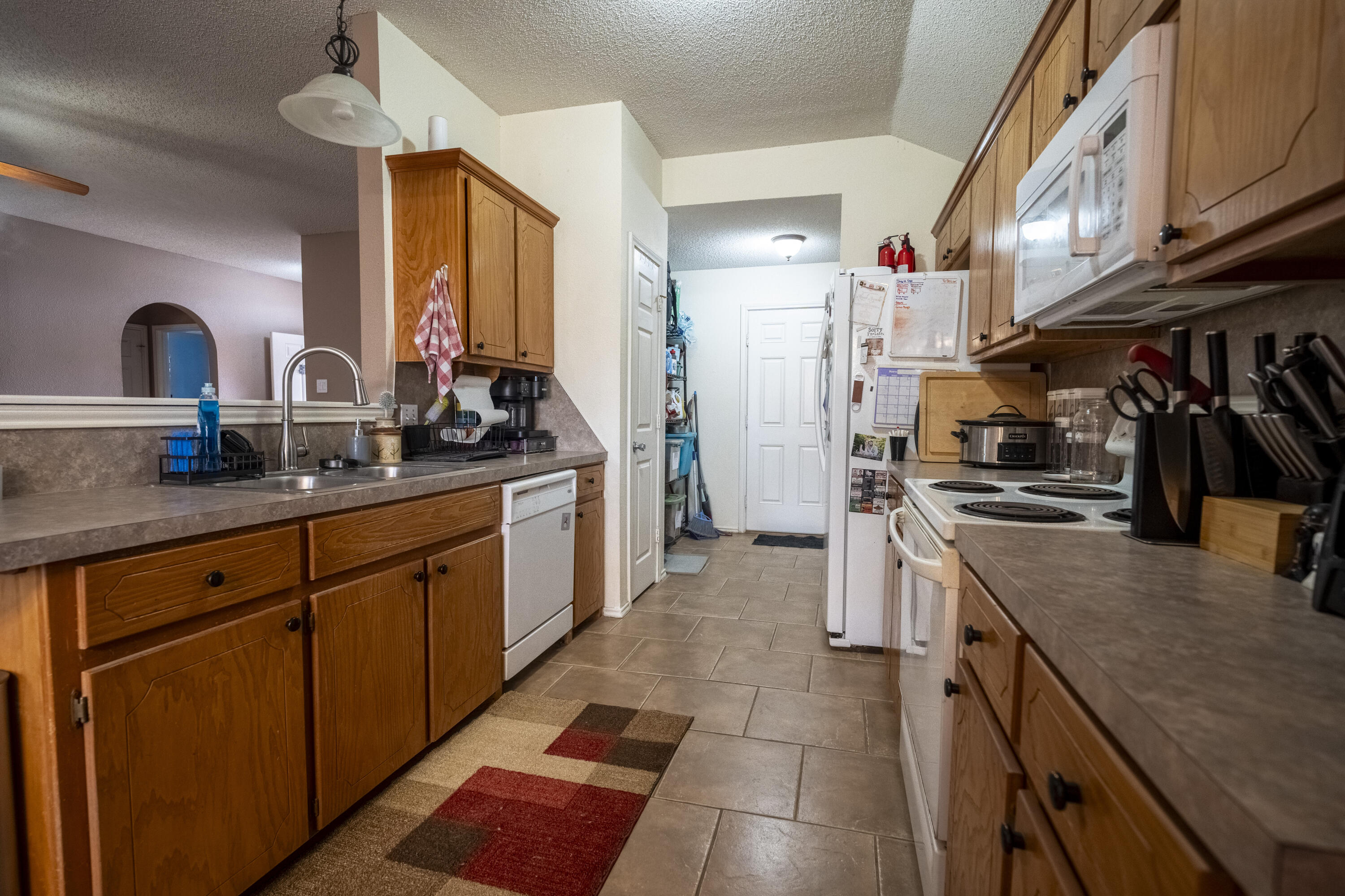 6319 13th Street Lubbock, TX 79416 - Photo 6 of 21 a kitchen with stainless steel appliances granite countertop a stove a sink and a refrigerator