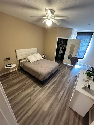 a bedroom with bed and a chandelier