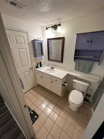 a bathroom with a sink mirror vanity and toilet