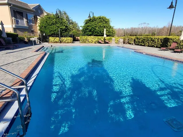 a view of a swimming pool and a yard