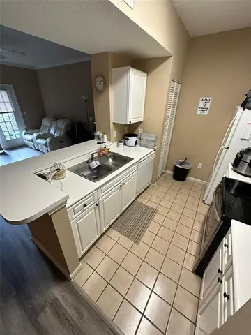a kitchen with a sink and a stove top oven